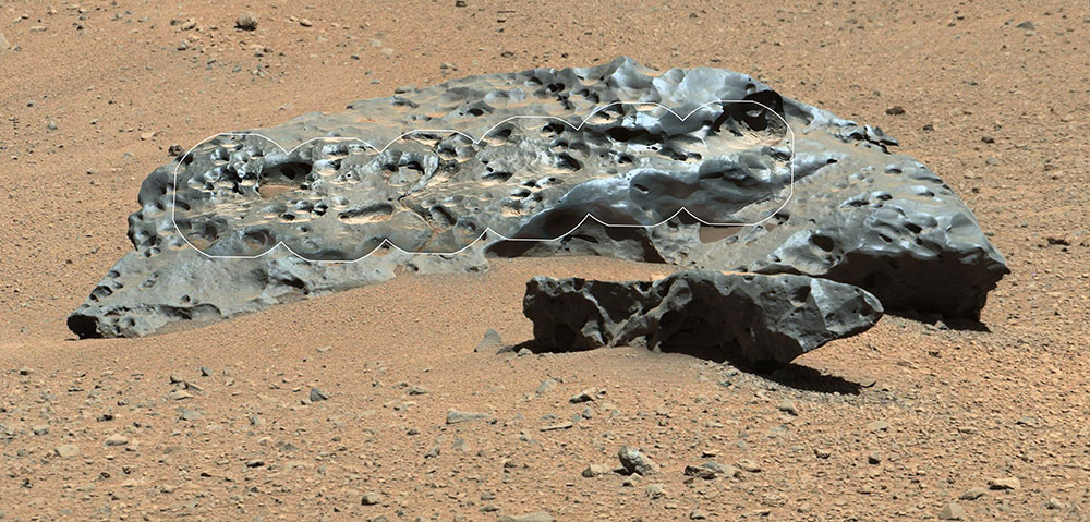 Two black meteorites on surface of mars.