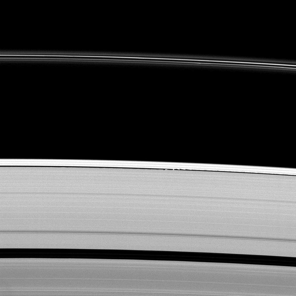 Daphnis is the bright spot in the narrow gap in the rings near the center of the image.