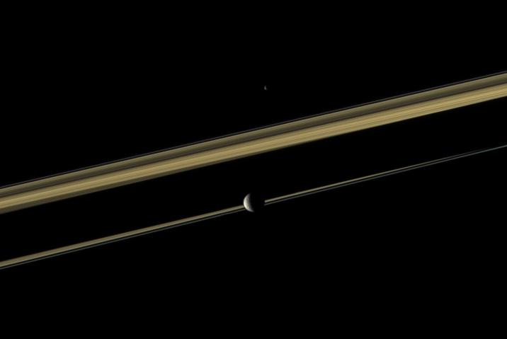 Two of Saturn's moons straddle the planet's rings in this color view.