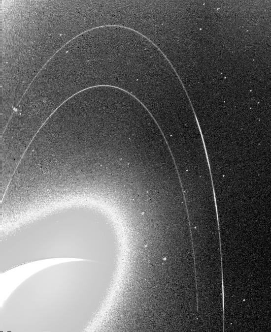 This wide-angle Voyager 2 image, taken through the camera's clear filter, is the first to show Neptune's rings in detail. 