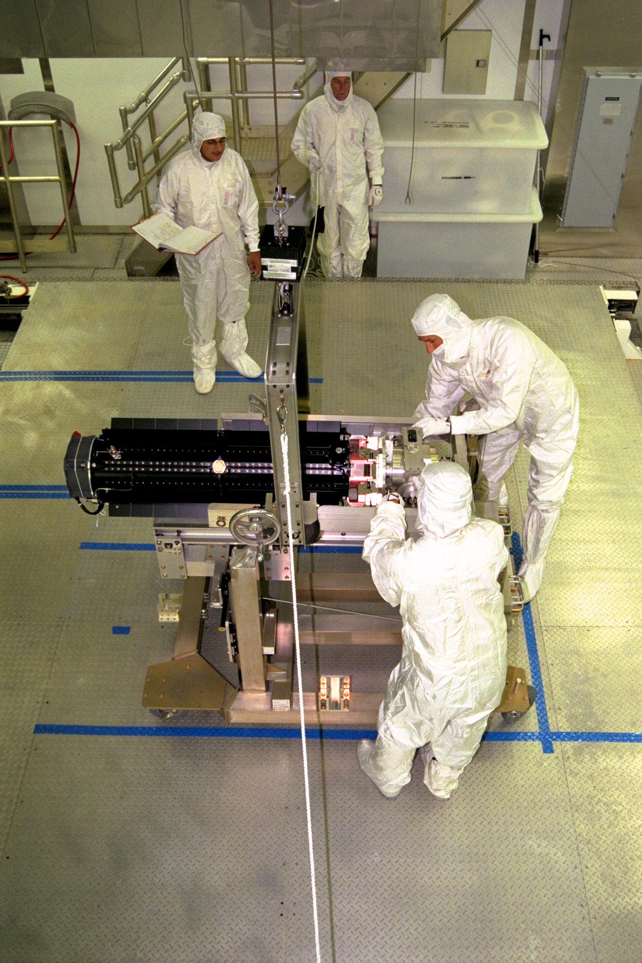 Men working with spacecraft parts.