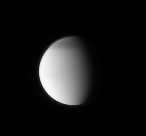 This ultraviolet view of Titan shows the moon's north polar hood and its detached, high-altitude haze layer.