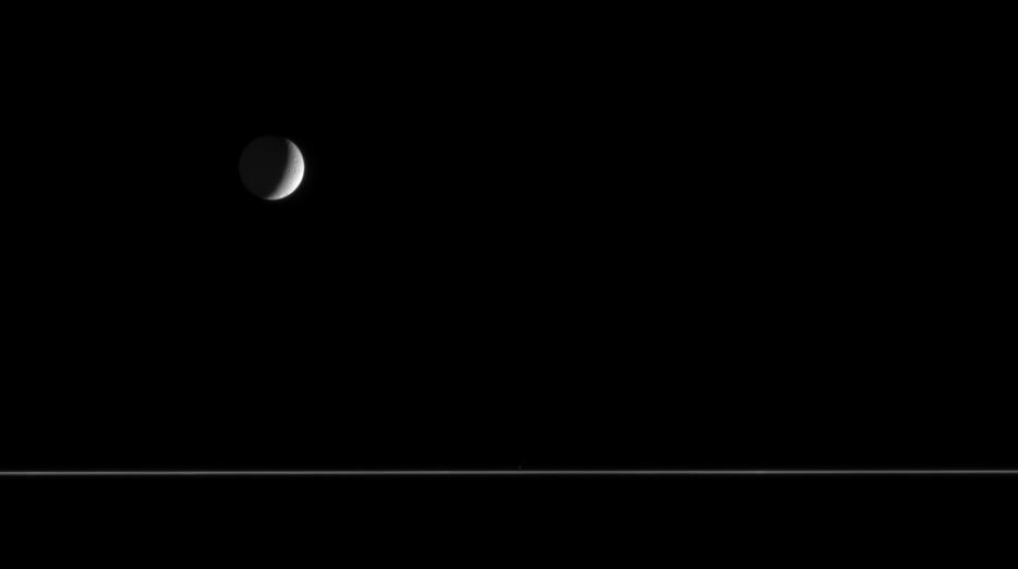 Tethys floats above the nearly edge-on rings of Saturn
