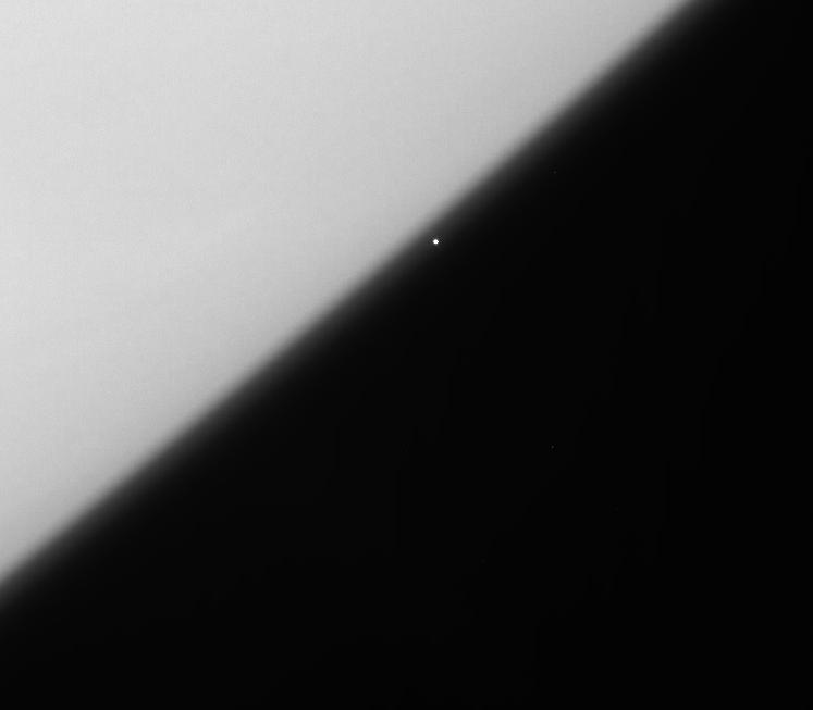 The brilliant supergiant star, Rigel, emerges from behind the haze of Saturn's upper atmosphere