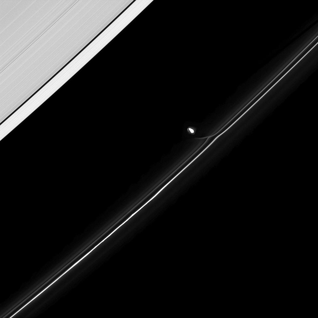 Fresh from an encounter with Saturn's F ring, the moon Prometheus continues in its orbit.