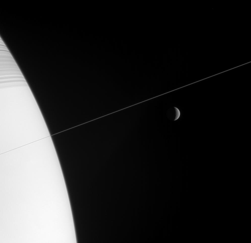 Saturn and a nearly edge-on view of the rings, along with Rhea