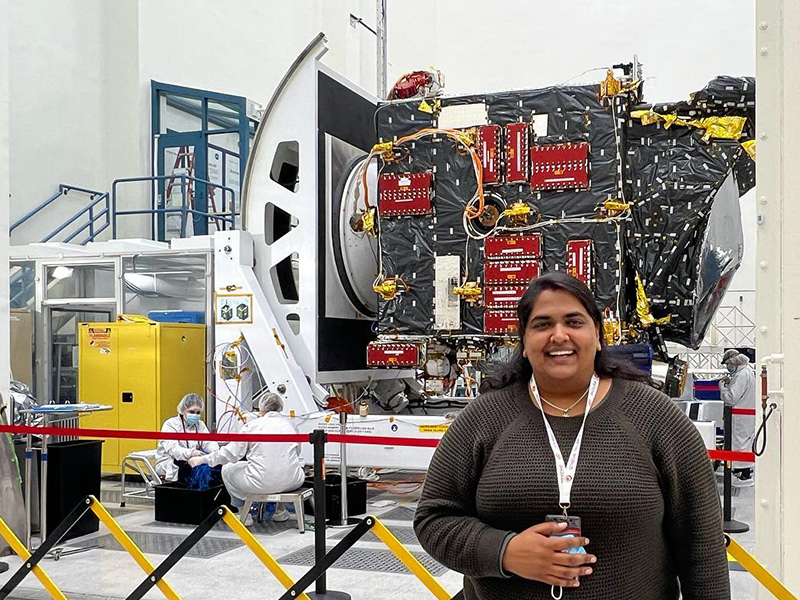 Image of Richa Sirohi standing in front of a spacecraft