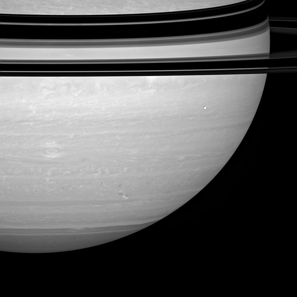 Saturn's storm and Enceladus