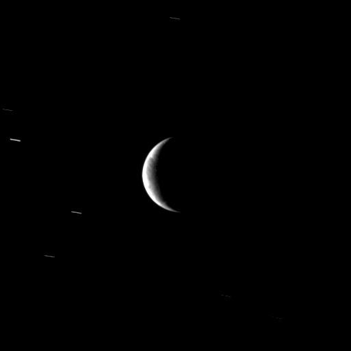 From a distant perspective, the Cassini spacecraft sees hints of the unusual surface of Saturn's moon Enceladus, a moon where new terrain is created around a geologically active south polar region.