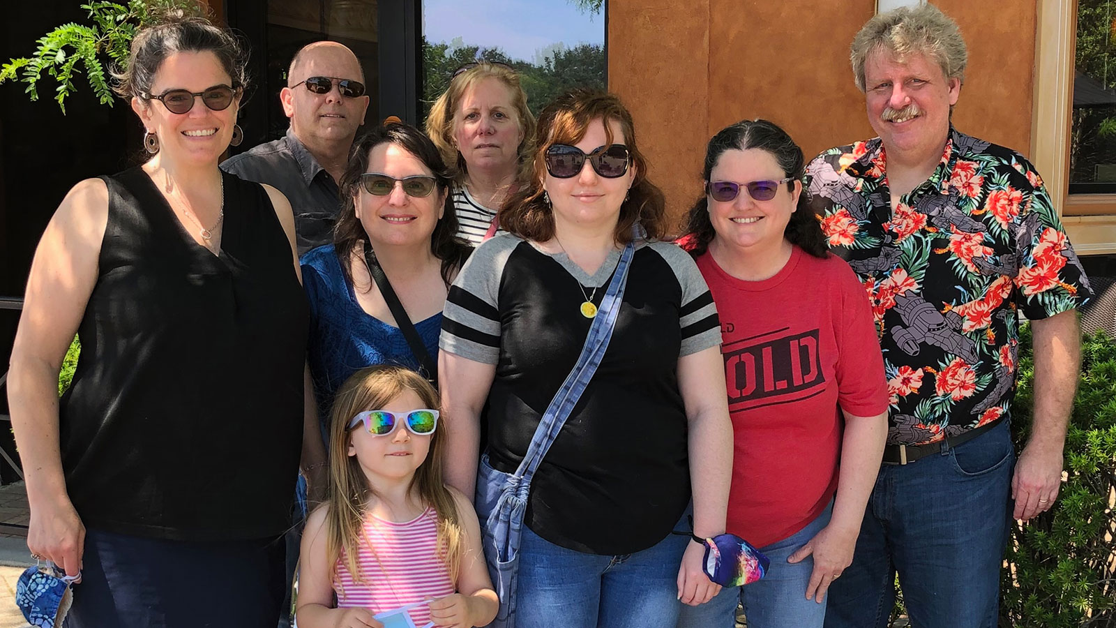 Mike is standing with seven other people in this family group photo.