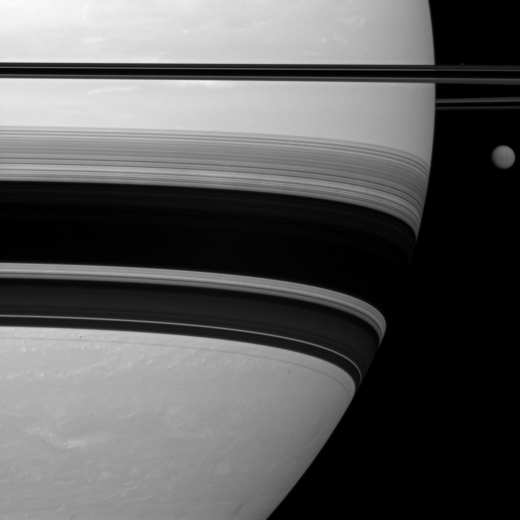 Saturn's largest moon, Titan, looks small here, pictured to the right of the gas giant in this Cassini spacecraft view.