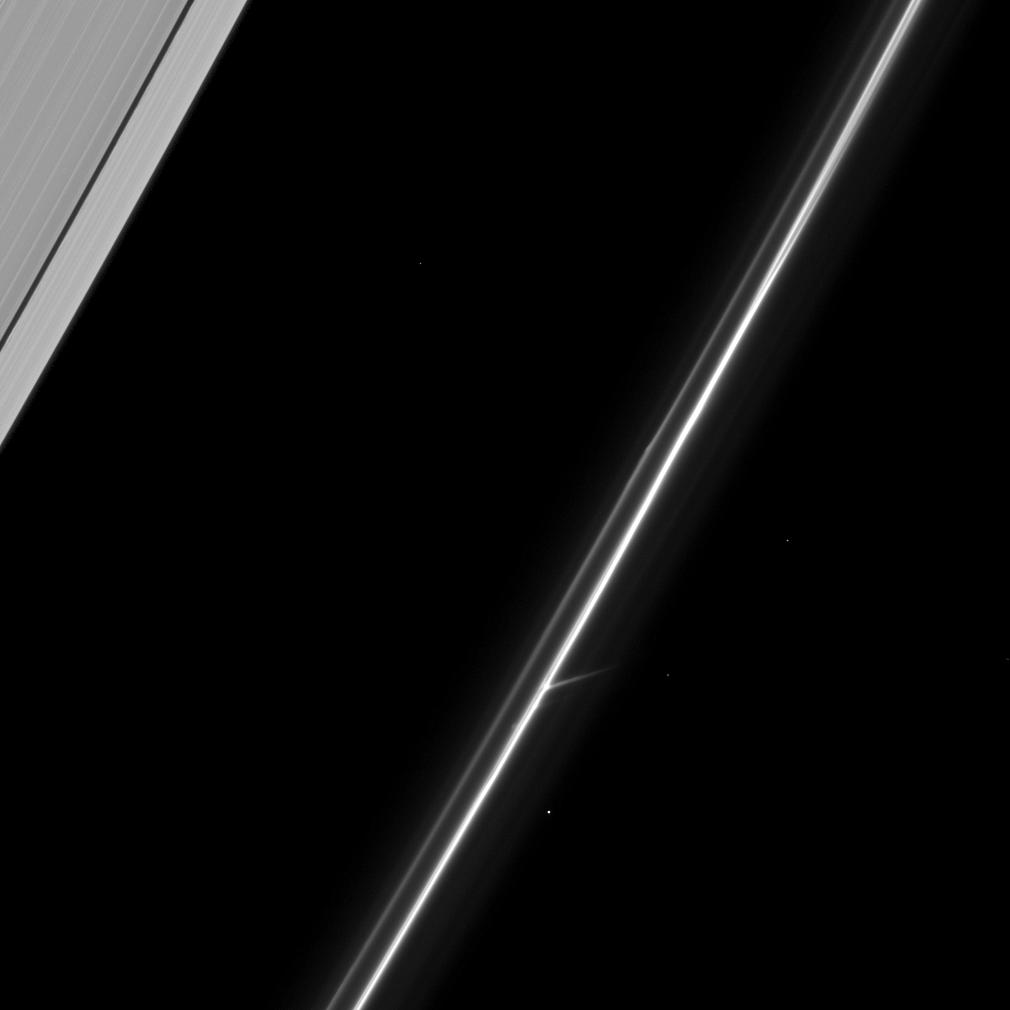 In the lower center of this image, the Cassini spacecraft captures an intriguing feature of Saturn's tenuous F ring.