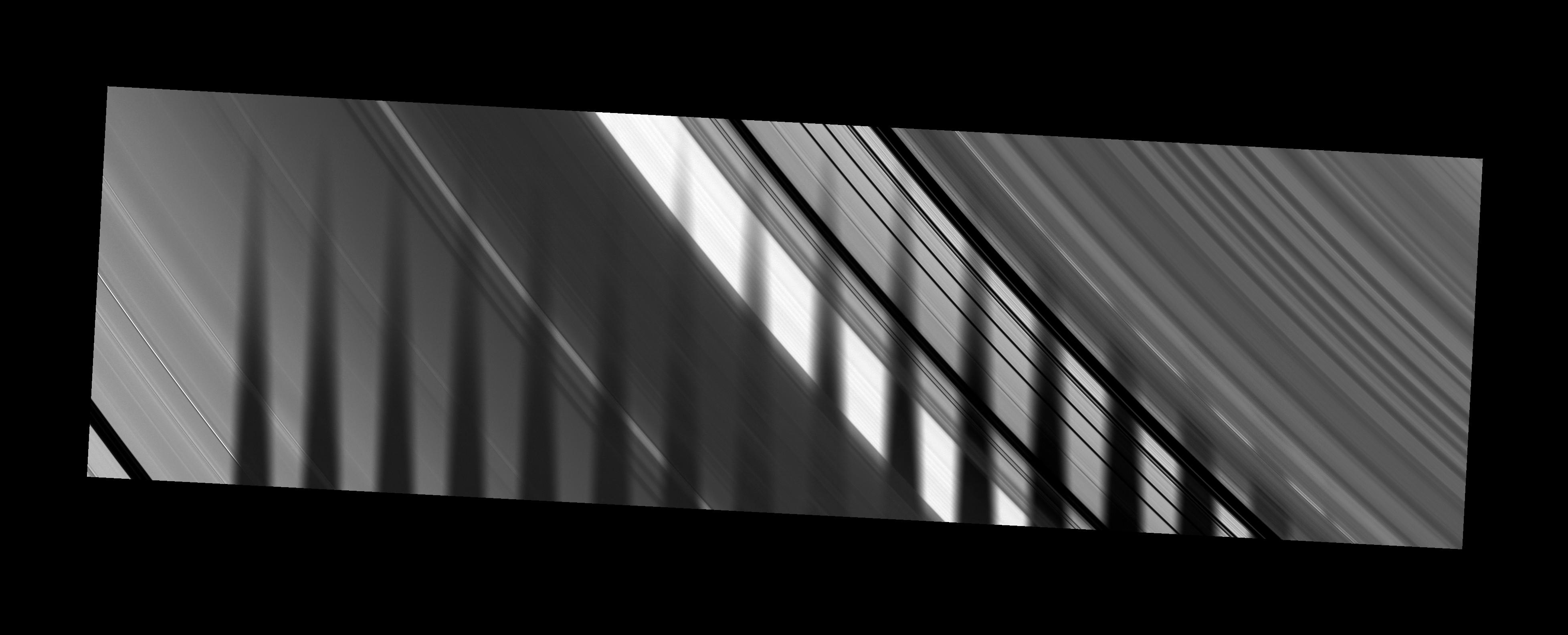 The shadow of Saturn's moon Tethys seems to disappear as it crosses the planet's rings
