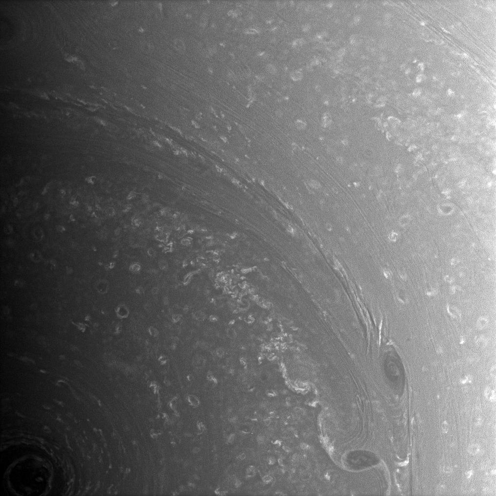 Bright, high-altitude clouds interact with dark, deeper structures near Saturn's south pole.
