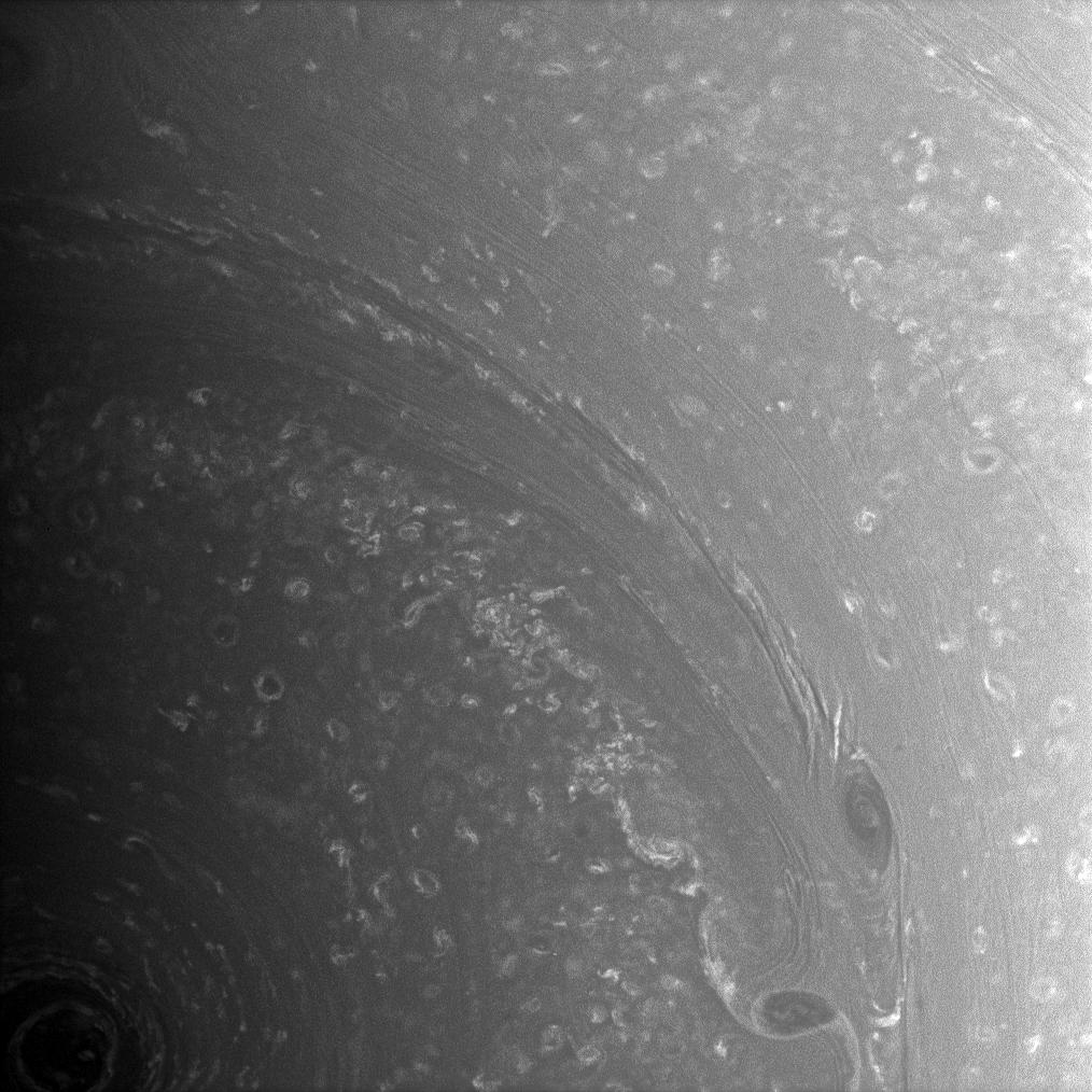 Bright, high-altitude clouds interact with dark, deeper structures near Saturn's south pole.
