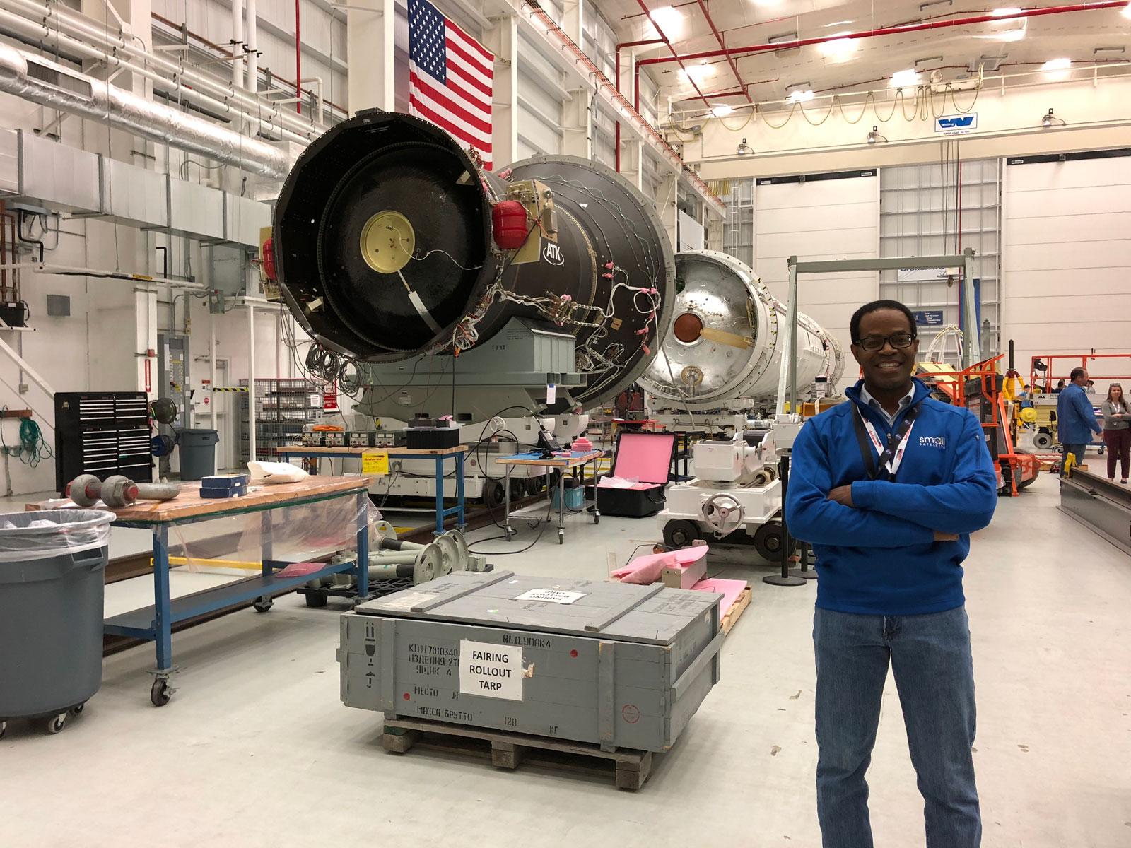 Charles Norton standing next to a rocket.