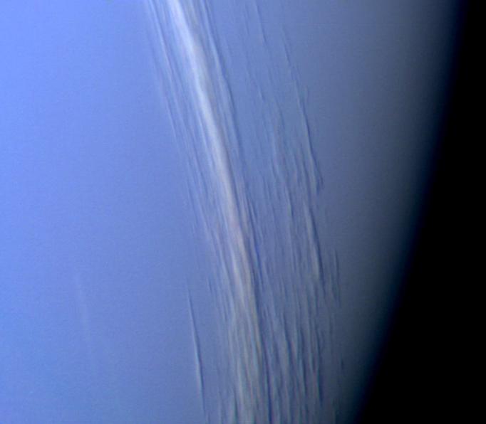 This Voyager 2 high resolution color image, taken 2 hours before closest approach, provides obvious evidence of vertical relief in Neptune's bright cloud streaks.