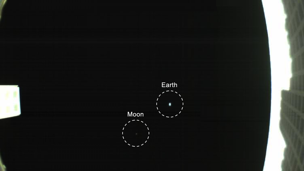 The CubeSat's unfolded high-gain antenna at right and the Earth and its moon in the center