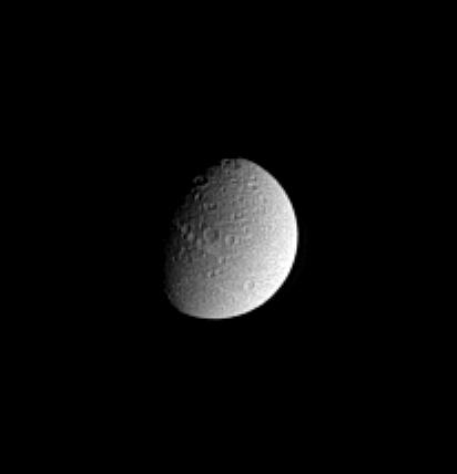 Black and White image of heavily cratered surface of Dione.