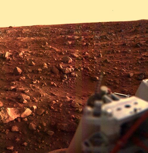 A rocky, red plain on Mars in twilight. 