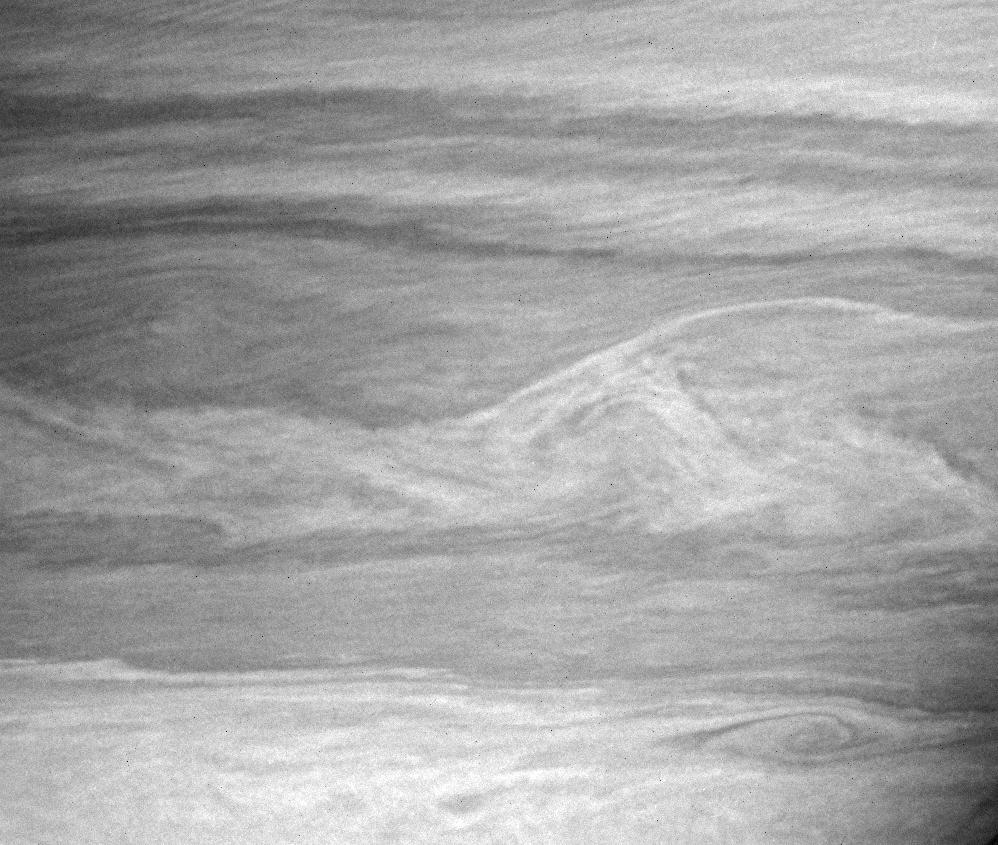 Vortices and wavy interfaces on Saturn