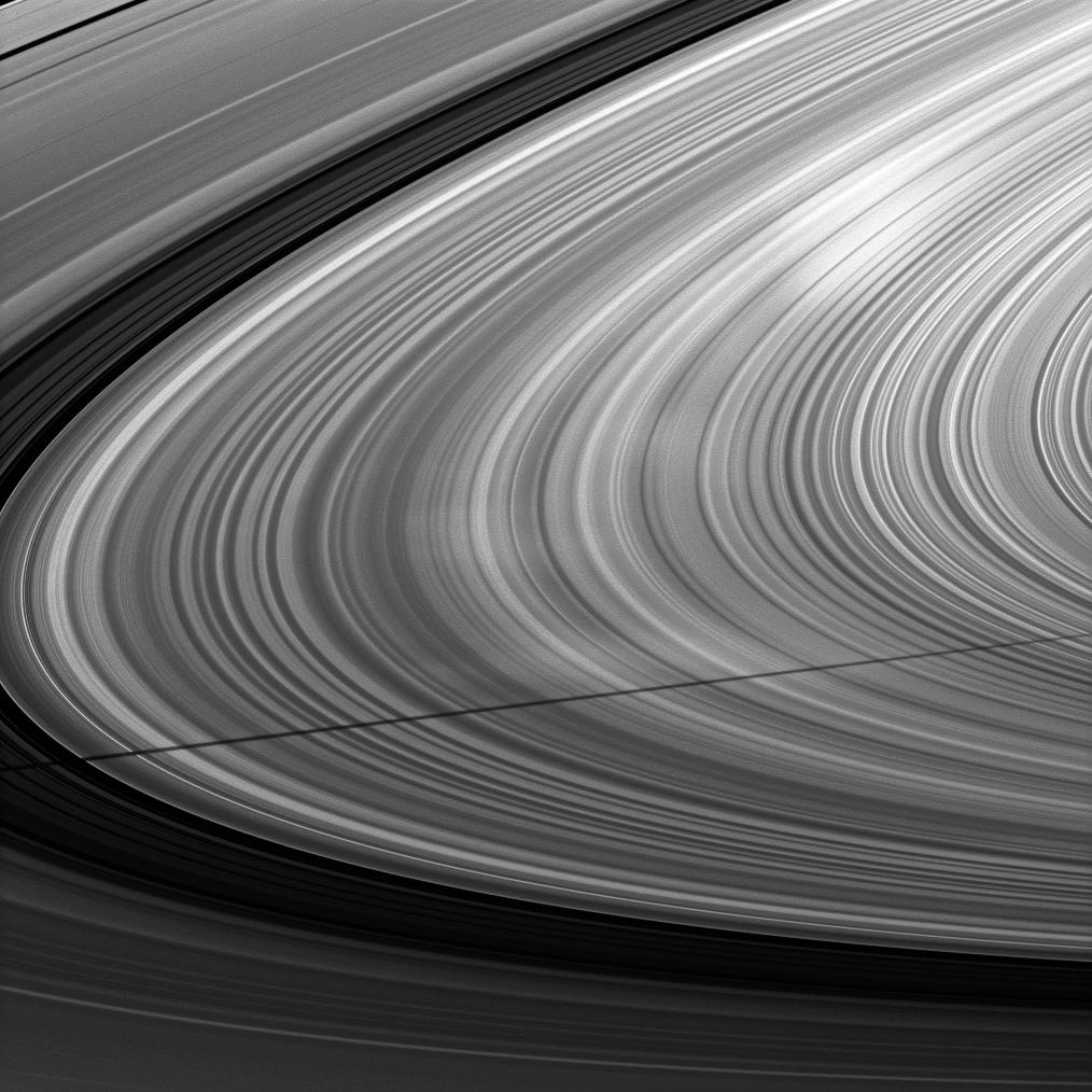 Mimas' shadow strikes Saturn's rings near bright spokes on the B ring