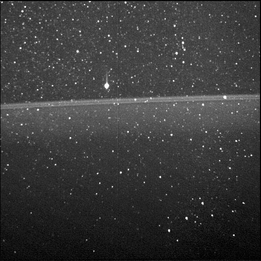 thin, horizontal ring visible in a field of stars