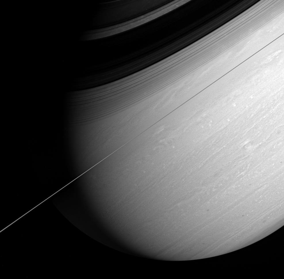 Saturn's whirling vortices and feathery cloud bands