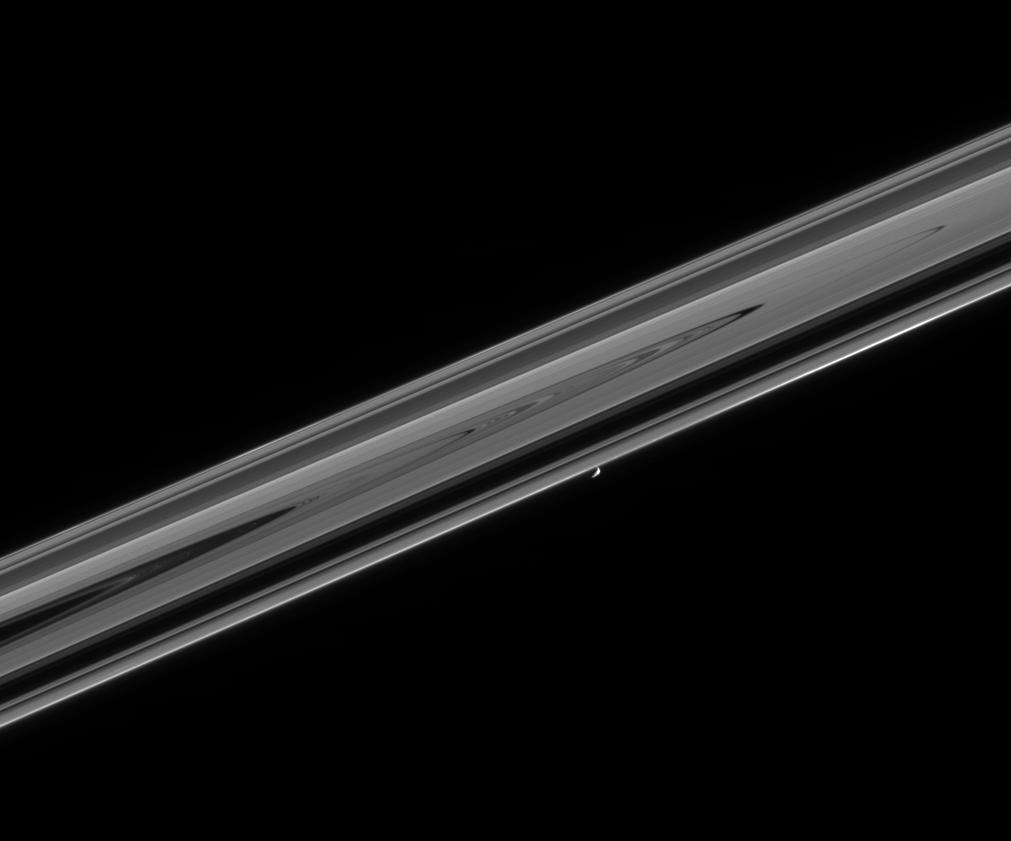 Saturn's moon Prometheus near a portion of Saturn's rings