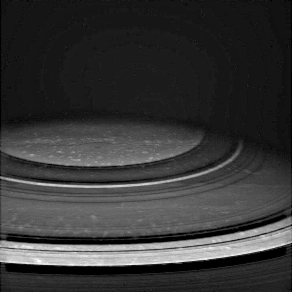 black and white image of Saturn showing cloud rings around the pole.