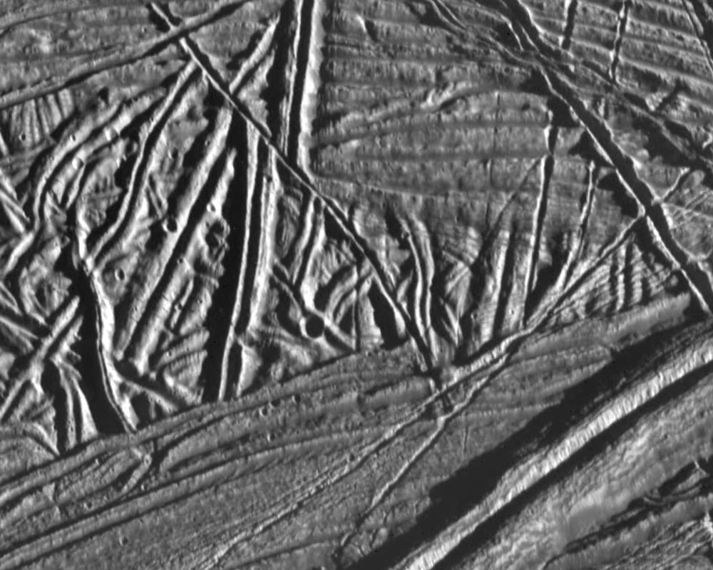 This high resolution image of the icy crust of Europa, one of Jupiter's moons, reveals a surface criss-crossed by multiple sets of ridges and fractures. 