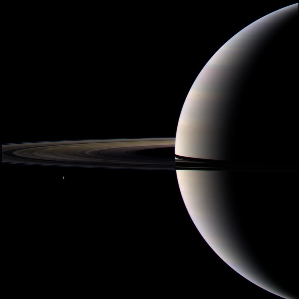 Looking cool and serene, Saturn shares its soft glow with Cassini.