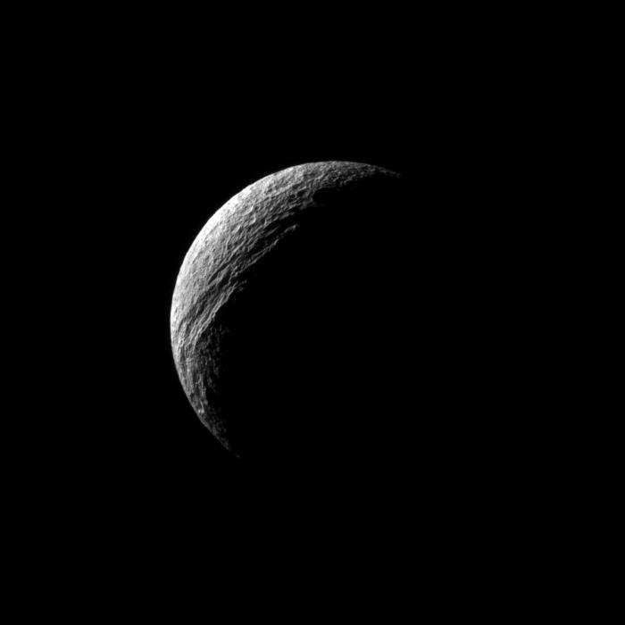 Sunlight illuminates the deep cut of Ithaca Chasma on Saturn's moon Tethys.