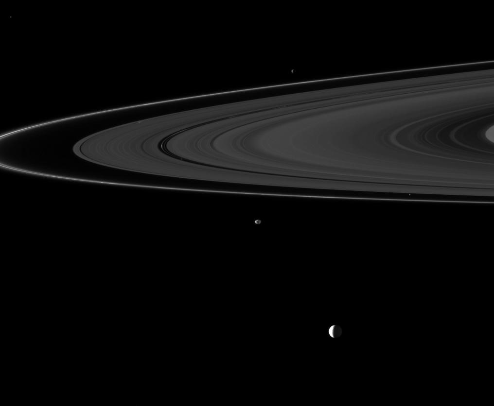 Six of Saturn's moons orbiting within and beyond the planet's rings are collected in this Cassini spacecraft image.