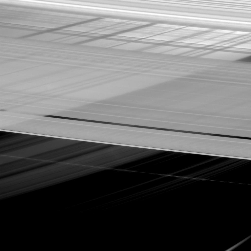 At first glance, Saturn's rings appear to be intersecting themselves in an impossible way. In actuality, this view from NASA's Cassini spacecraft shows the rings in front of the planet, upon which the shadow of the rings is cast. 