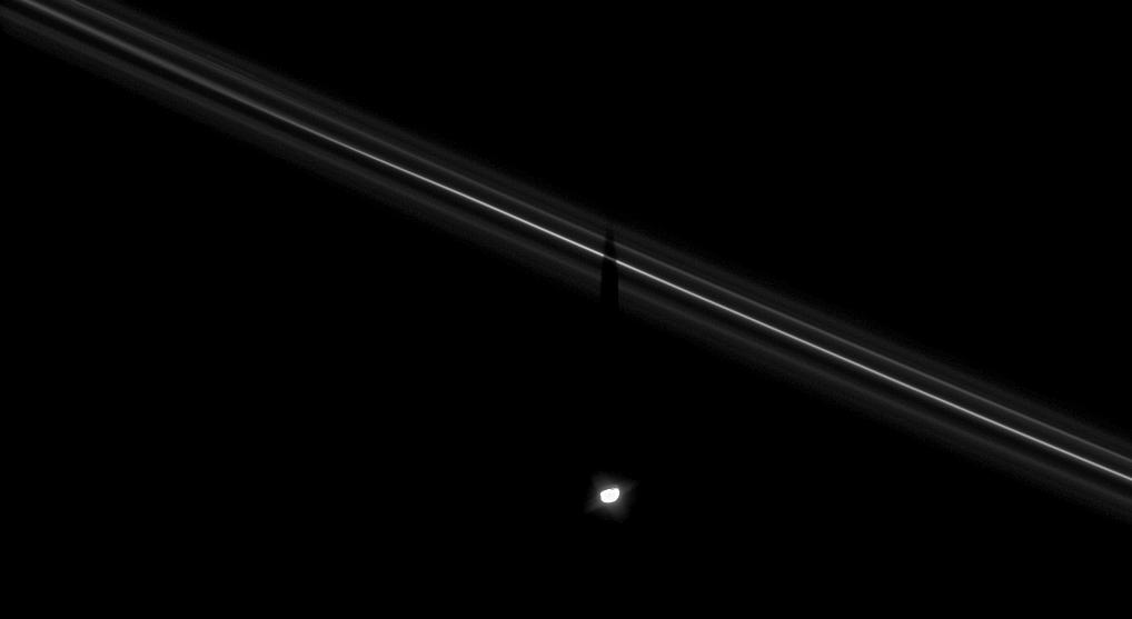 Saturn's moon Pandora casts its shadow upon the F ring. 