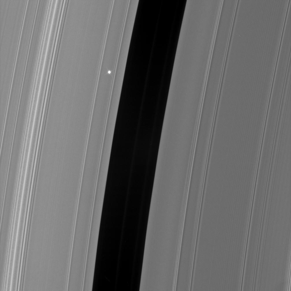 The bright red giant star Aldebaran slip behind Saturn's rings
