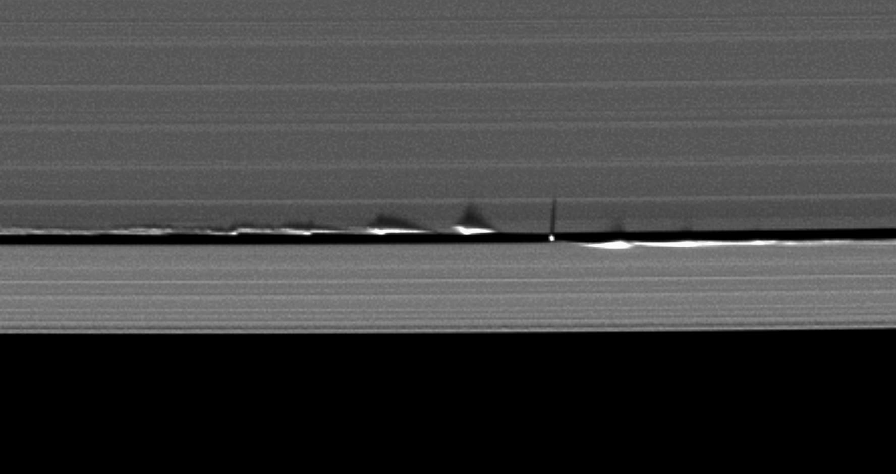 Never-before-seen looming vertical structures created by the tiny moon Daphnis