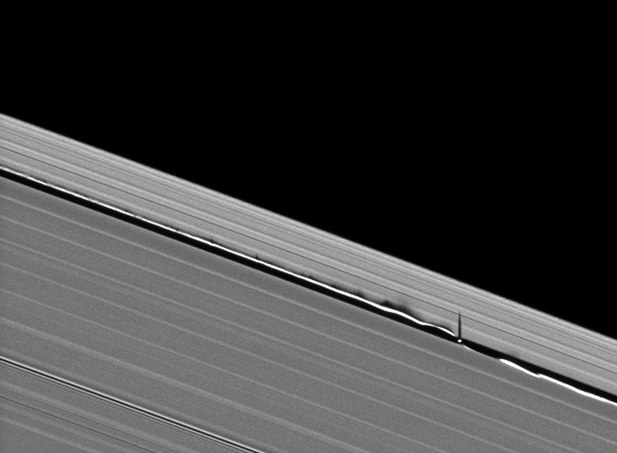 Vertical structures created by Saturn's small moon Daphnis cast long shadows across the rings in this dramatic image taken as the planet approaches its mid-August 2009 equinox
