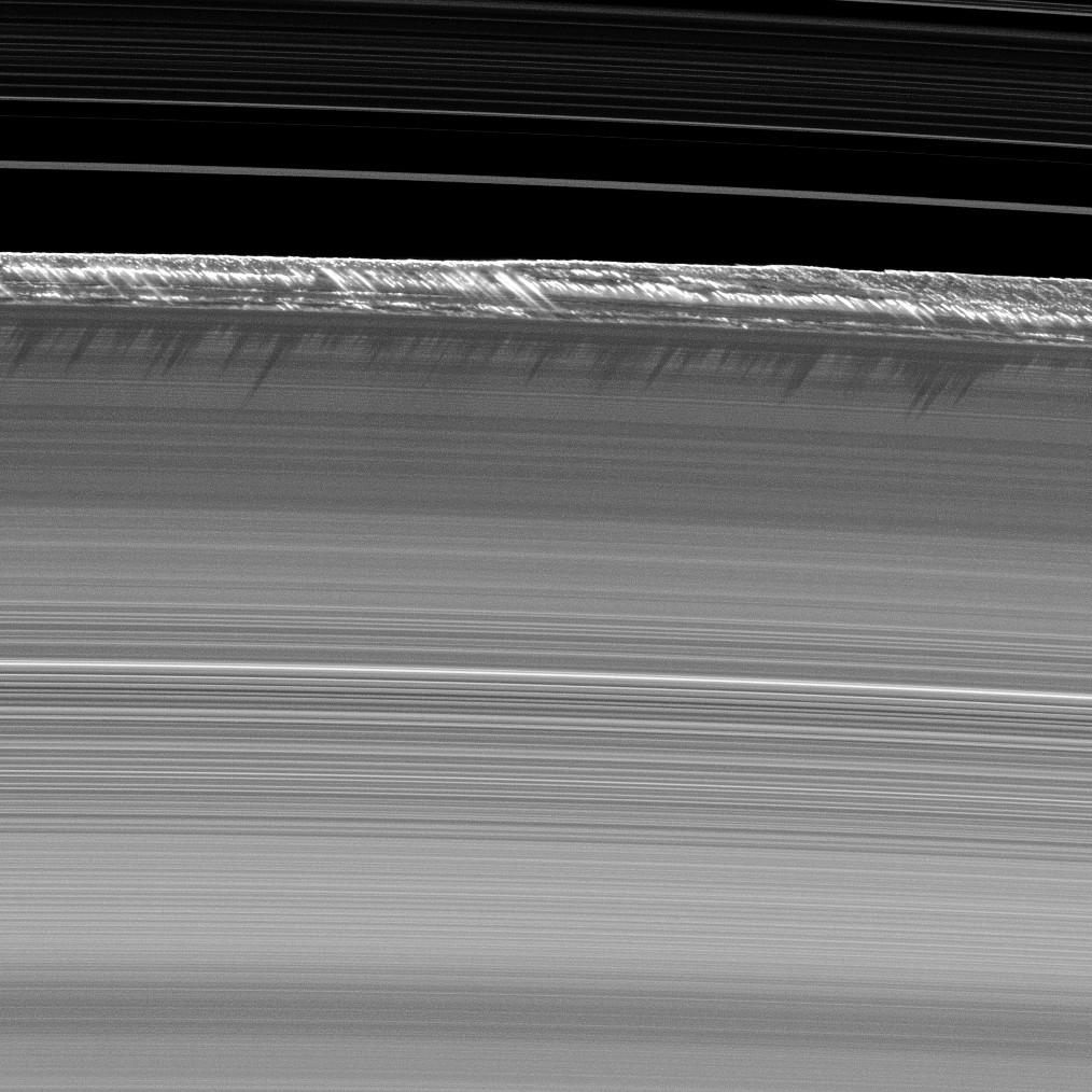 Vertical structures, among the tallest seen in Saturn's main rings, rise abruptly from the edge of Saturn's B ring to cast long shadows on the ring in this image taken by NASA's Cassini spacecraft two weeks before the planet's August 2009 equinox.