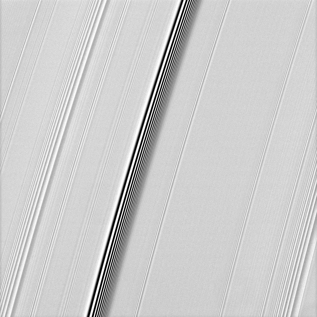 The Cassini spacecraft spies two types of waves in Saturn's A ring: a spiral density wave on the left of the image and a more pronounced spiral bending wave near the middle.