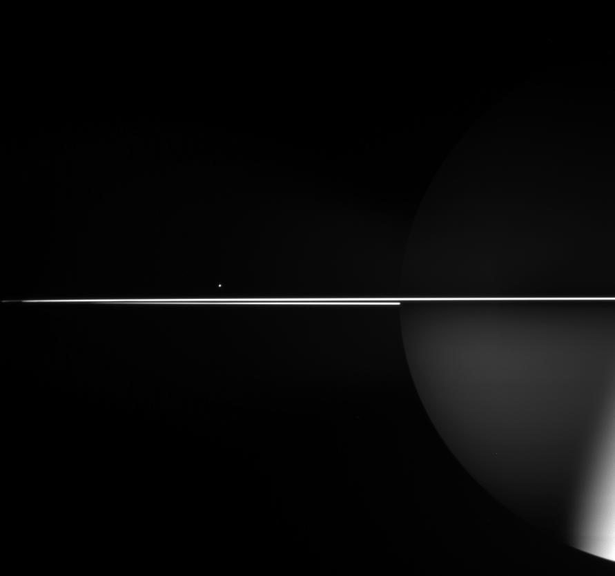 tiny Mimas behind the rings of Saturn