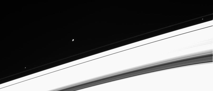Three of Saturn's moons near the rings