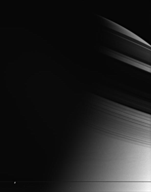 The shadow of Saturn's rings on the atmosphere of Saturn. Enceladus is in the foreground