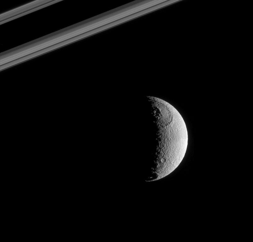 Tethys near a portion of Saturn's rings