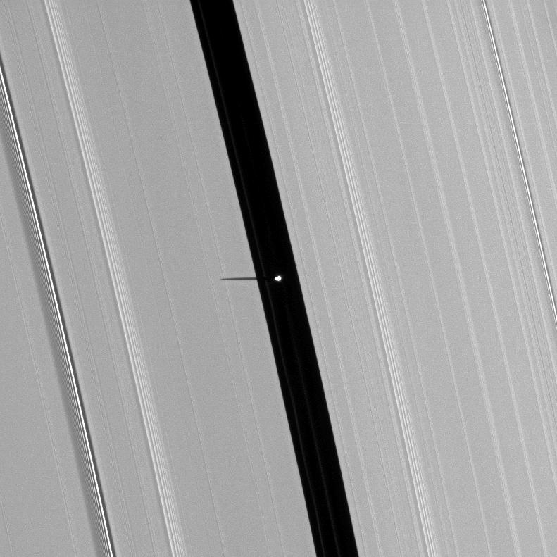 Saturn's small moon Pan, brightly overexposed, casts a short shadow on the A ring in this image taken before the planet's August 2009 equinox.