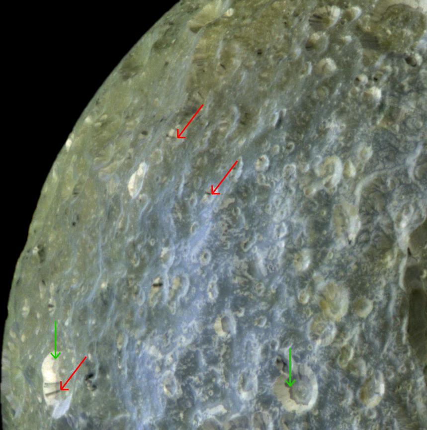 This false-color view of Mimas accentuates terrain-dependent color differences and shows dark streaks running down the sides of some of the craters
