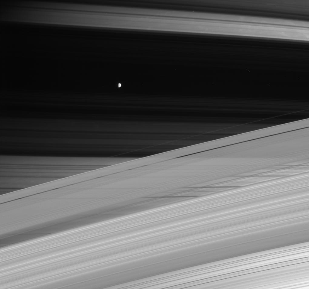 Saturn, its rings and its small, icy moon Mimas