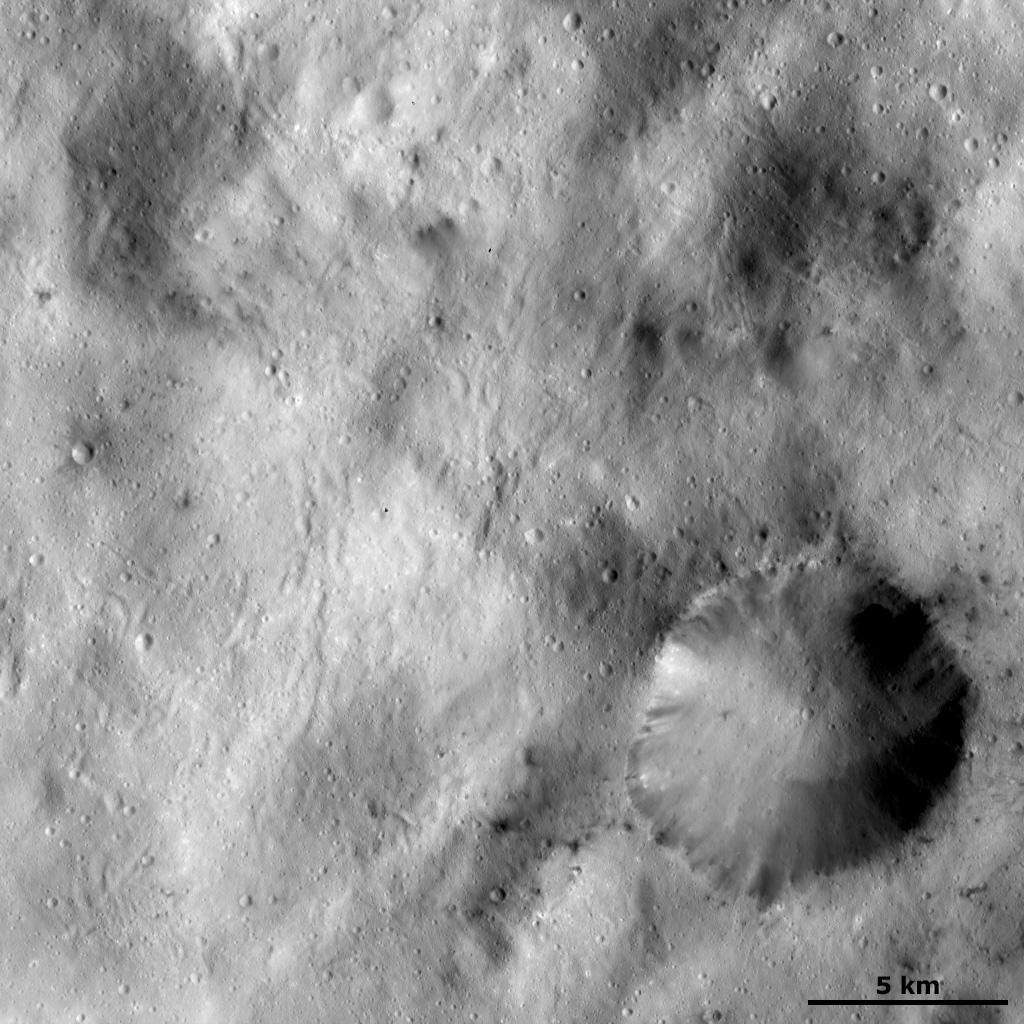 Spots of Dark Material Surrounding an Impact Crater