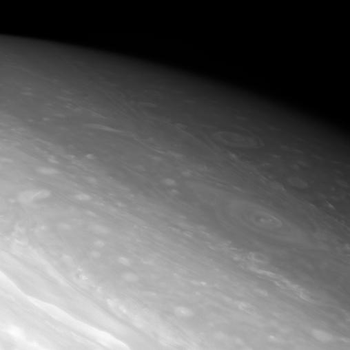 Giant vortices swirl in the dim northern latitudes of Saturn.